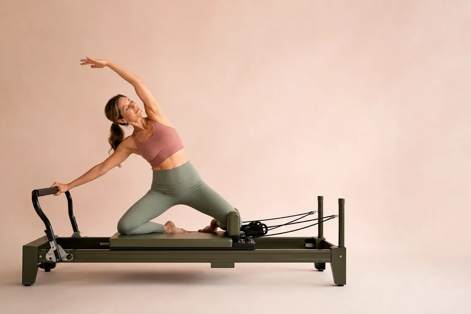 Mujer realizando un movimiento lateral controlado sobre un reformer